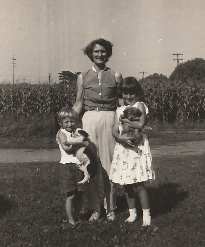Taken around 1960 - Hunterdon County, New Jersey. With Mom and Sis, loving puppies. Copyright 2015 Genealogy Sisters.